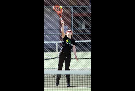 Maddy Sevier serves during singles play.