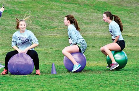 Charlo High School students bounce through the obstacle course.