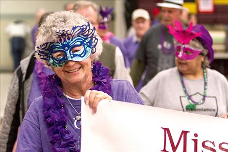 Nineteen-year survivor Nancy Williams carries the Mission Valley Methodist Church relay team’s banner during the survivors’ walk.