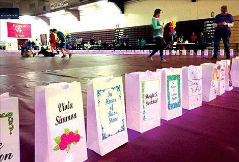 Luminaria glow with battery-operated candles on the gym floor.