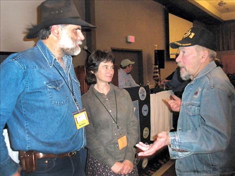 Greg and Deb Schatz of Columbia Falls speak with an attendee following their slide show on Friday about a visit to Mongolia last summer.