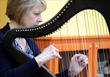 Harpist Debbie Conrad strums Celtic folk tunes