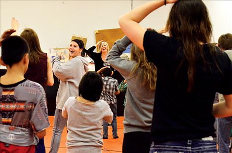 Linda Sappington shows the kids how to do Zumba moves in Ronan.