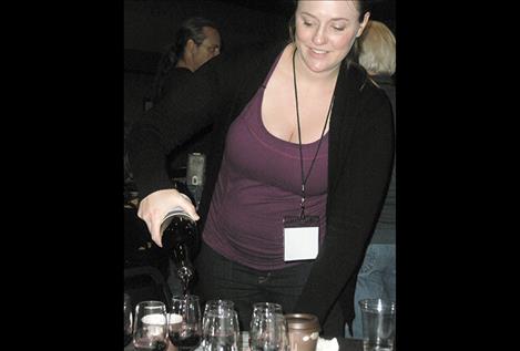 Alyssa Griffith of Bozeman serves wine for testing activity Friday afternoon.