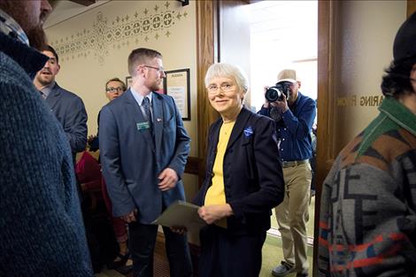 Carole Mackin, a taxpayer from Helena, is escorted out of a hearing room at the Montana Capitol by a sergeant-at-arms Thursday, March 23, after she refused to stop her testimony in support of Senate Bill 305, which would allow mail ballot elections. Testimony for and against the bill were both given 20 minutes.