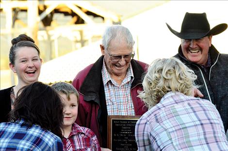 Bud Harris shares his Ronan Chamber of Commerce Agriculture Appreciation award with his family.