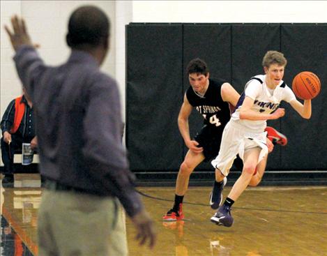 Dalton Delaney races against the clock as Charlo coach Mike Brown watches.