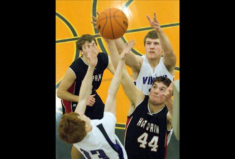 Tristan Santee stretches for a rebound over Hot Springs' Dave Cross.