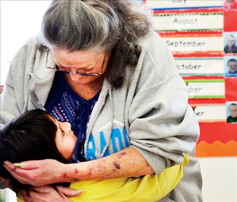 Karen Hess, 5, hugs the grandma she saved.