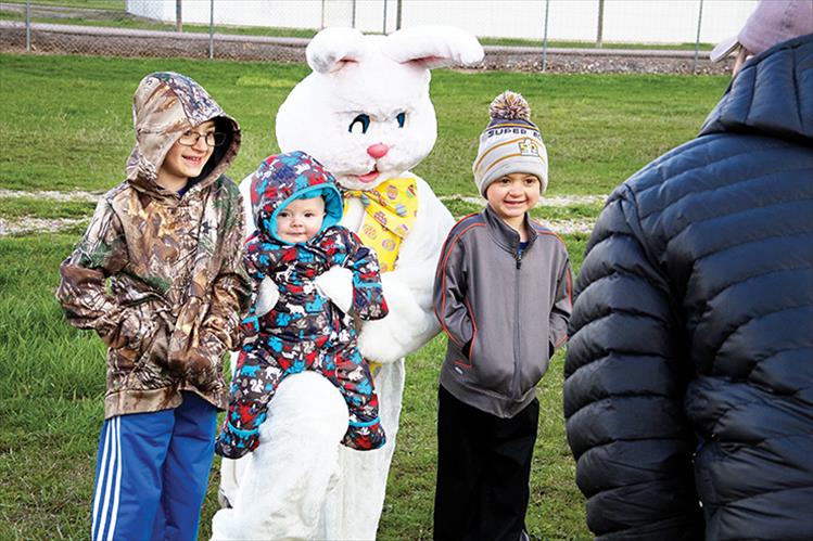 Brothers Jackson, Elliott and Riley Bontadelli pose for a photo with the Easter bunny after the Polson egg hunt.