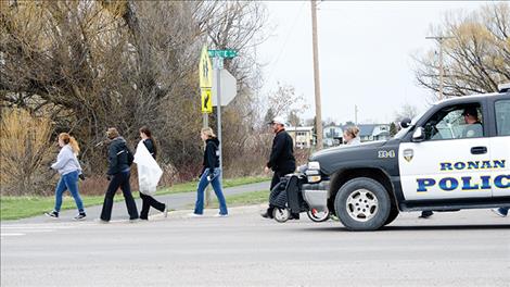 Ronan police officers keep kids safe while they work. 