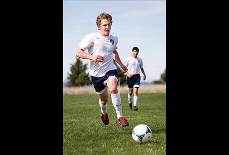 Polson’s Mack Moderie races for the ball.