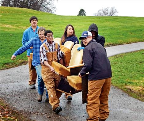 Griffen Reed, Seth Clary (Facilities Maintenance Instructor), Samantha Porambo, Tory Johnson, Aldraindo Gene and Justin Shephard help remove old theatre seats and install new ones.