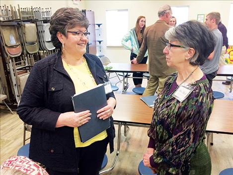 Peggy Mathiason and MVCA Curriculum Director Carolyn Hall visit during the event while  Chris Martineau talks with MVCA students in the background. 