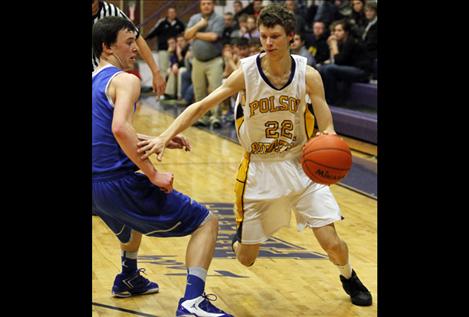 Derek Peel drives around a Corvallis defender Feb. 8. Peel, a sophomore, has put up big numbers for Polson this season.