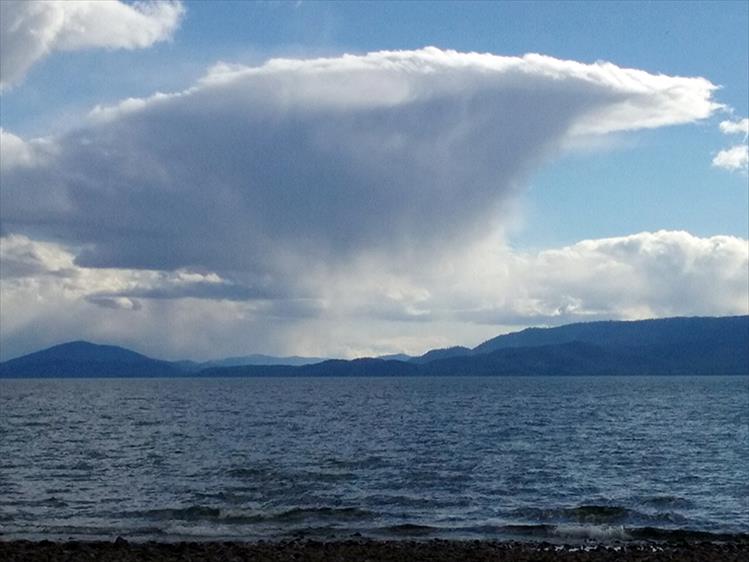 A spring storm brings precipitation and stirs up small waves on Flathead Lake.