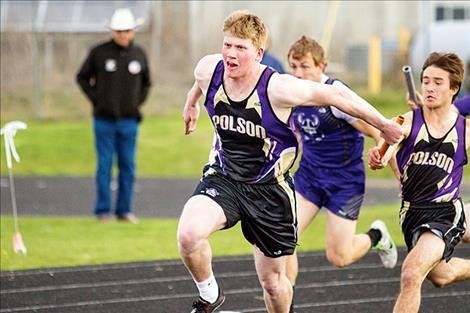 Pirates Matthew Rensvold and Danny DiGiallonar do exchange baton during the 400 relay.