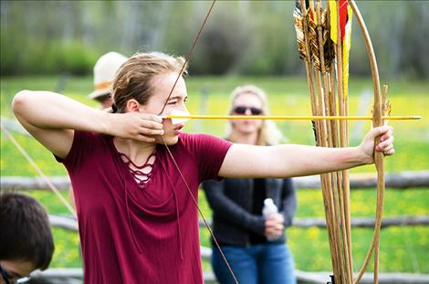 Kyla Tomlin, 14, tries the long bow set up at the event.