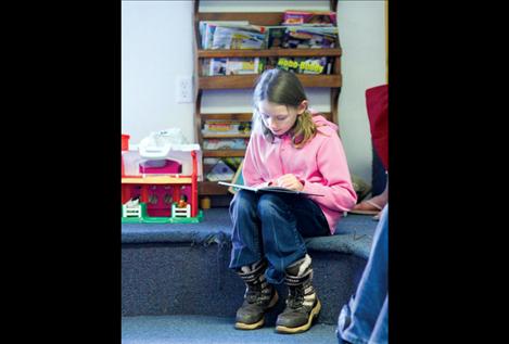 Tiana Crist reads from one of her favorite books at the Ronan Public Library on a cold and rainy February day.