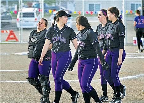 The Polson Lady Pirates share a happy moment after defeating Columbia Falls.