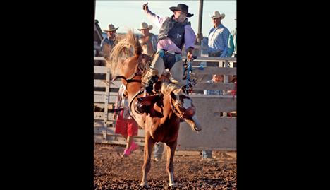 Travis Dumont spurs one of Elmo McDonald’s tough  saddle broncs. 