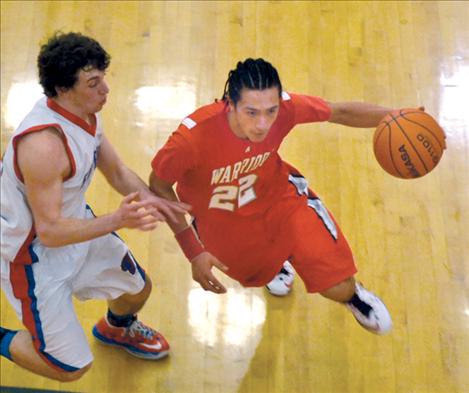 Arlee point guard Zack Camel drives to the bucket during the District 14-C tournament two weeks ago. During the Western C divisional tourney last weekend, Camel set a new state record for assists in a season with 248 assists. The old record, set in 1994-95, was 230.