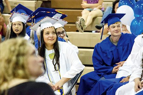  Shaniya Decker watches a slide show of classmates during the Mission graduation ceremony.