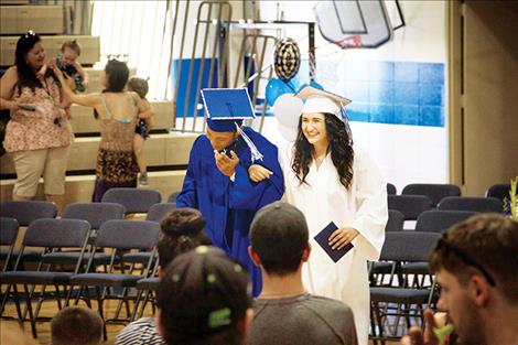  Suzannah Clark and Leondre Bolen walk together after receiving their diplomas.