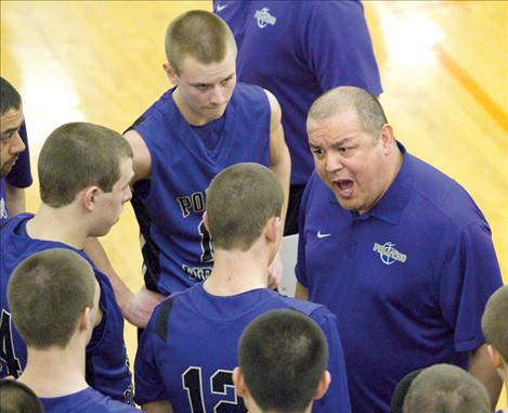 Pirate head coach Brad Pluff rallies the troops during Polson’s game against Columbia Falls Friday. The Pirates all sported shaved heads for the divisional tournament.