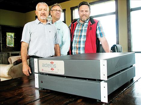 Adelos’ employees Scott Colton, Dermot O’Halloran and Alex Philp stand next to the company’s world class, fiber optic acoustic sensor. 