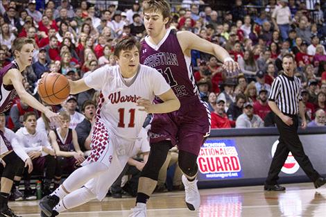 Arlee’s Tyler Tanner drives past a Manhattan Christian’s defender during the state championship game.