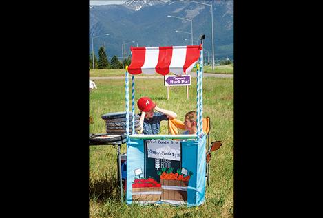 Cousins Moses and Carter Curtiss, 9, sell rhubarb and mint from their Grandma Rosie’s garden.