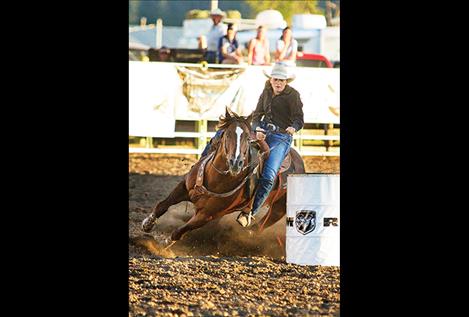 Polson cowgirl makes the turn on barrel two.
