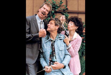 Neal Lewing, Todd Mowbray and Karen Lewing are pictured at right in a scene from the Port Polson Players’ 1999 performance of Murder at the Howard Johnson’s. The trio have performed the play in their 30s, 40s, 50s and now 60s using  the same costumes, set and props.