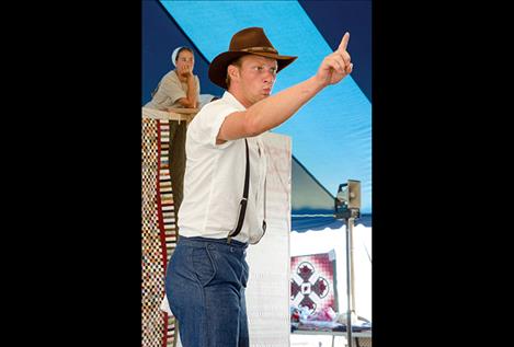 Caleb Troyer enthusiastically catches a bid during the 15th annual Amish Community Auction.