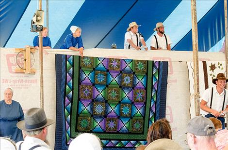 Karen Peterson/Valley Journal Auctioners sell off colorful quilts created by Amish communities all over the country.