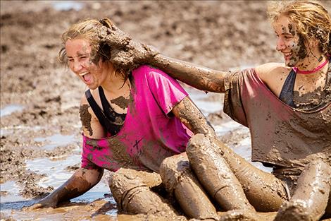 Olivia and Claudia Hewston share some mud and laughs.