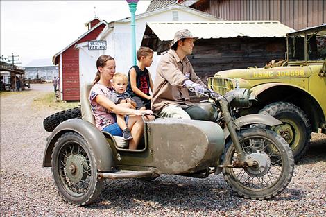 David Bosley gives Leroy, Aiden and Nicole Burland a ride on a retired military motorcycle. The motorcycle and several other retired military vehicles are used during Live History Days to give rides around the museum grounds.
