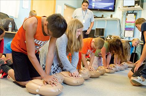 Kids learn CPR skills during a two-day training program.