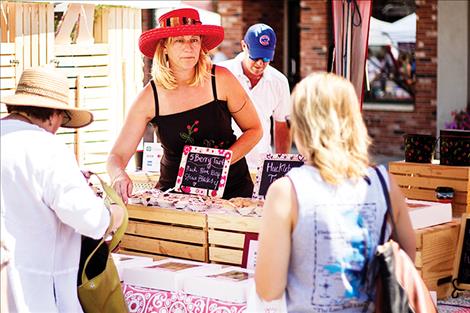 Genevieve of Genevieve’s Hot Pies waits on pie seeking customers in downtown Polson.