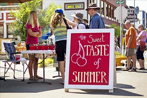 Visitors to the annual cherry festival stop to purchase cups of cherries.