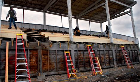 Workers replace grandstand seats at the Polson Fairgrounds.