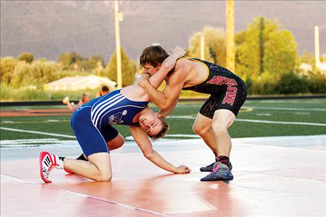 Mission Vallely wrestler Jamie Peterson attempts to pin his opponent.