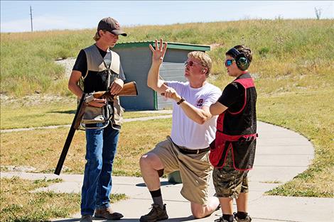 Tristan Oberwegner and Isaac Cantlon get coached before going into the 5 Stand event at the 4H Shotgun competition.