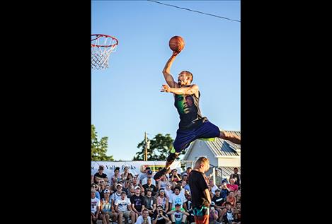 Deon McLaughlin flies through the air during the slam dunk competition.