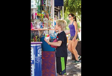 A young ball player grabs a cool snack after a game.