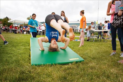 Owner of Head Over Heels, Jessica Edwards, demonstrates tumbling skills for her students.