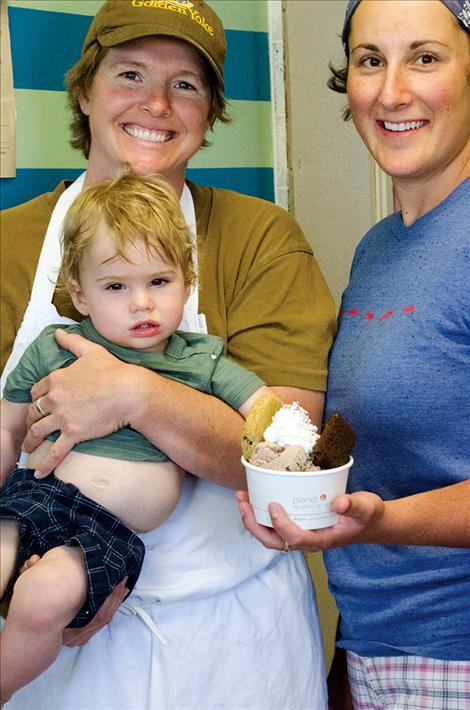 Connie Surber, Laura Ginsburg, and Finn Surber-Ginsburg sell ice cream at their new shop.  