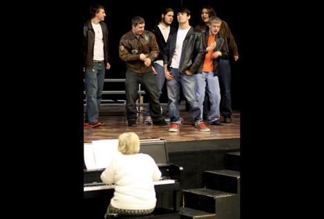 Tingey sings and plays piano while cast members sing, dance and act during a recent rehearsal of ‘Grease.’ 