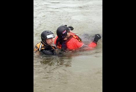 Gabe Ouellette, a member of Lake County Search and Rescue, is a rescue swimmer, or “live bait,” in the Swan River as he and a victim are pulled to shore with a rope during a training in May. 